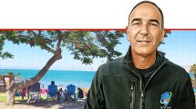 אריק טל מנהל יחידת פיקוח ואכיפה באיגוד ערים כינרת, ברקע: מבלים בצֵל בחוף צמח, צילום; טלי בר | עיבוד: Photolab | עיבוד צילום: שולי סונגו ©